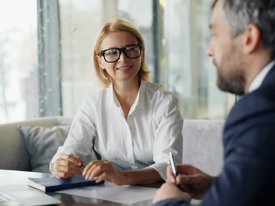 An adviser and a client talking at a table